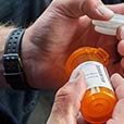 Pouring pill bottle into hand
