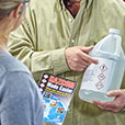 man holding hazardous chemical jug