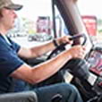 Man with ballcap driving semi truck