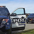 Parked police vehicle with driver door open