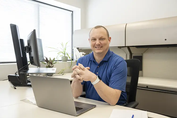 A worker at a desk in his office with computer