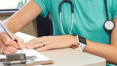 Nurse completing paperwork