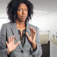 Alarmed woman holds her hands up in defense.