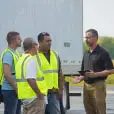 Trainer talking to student drivers.