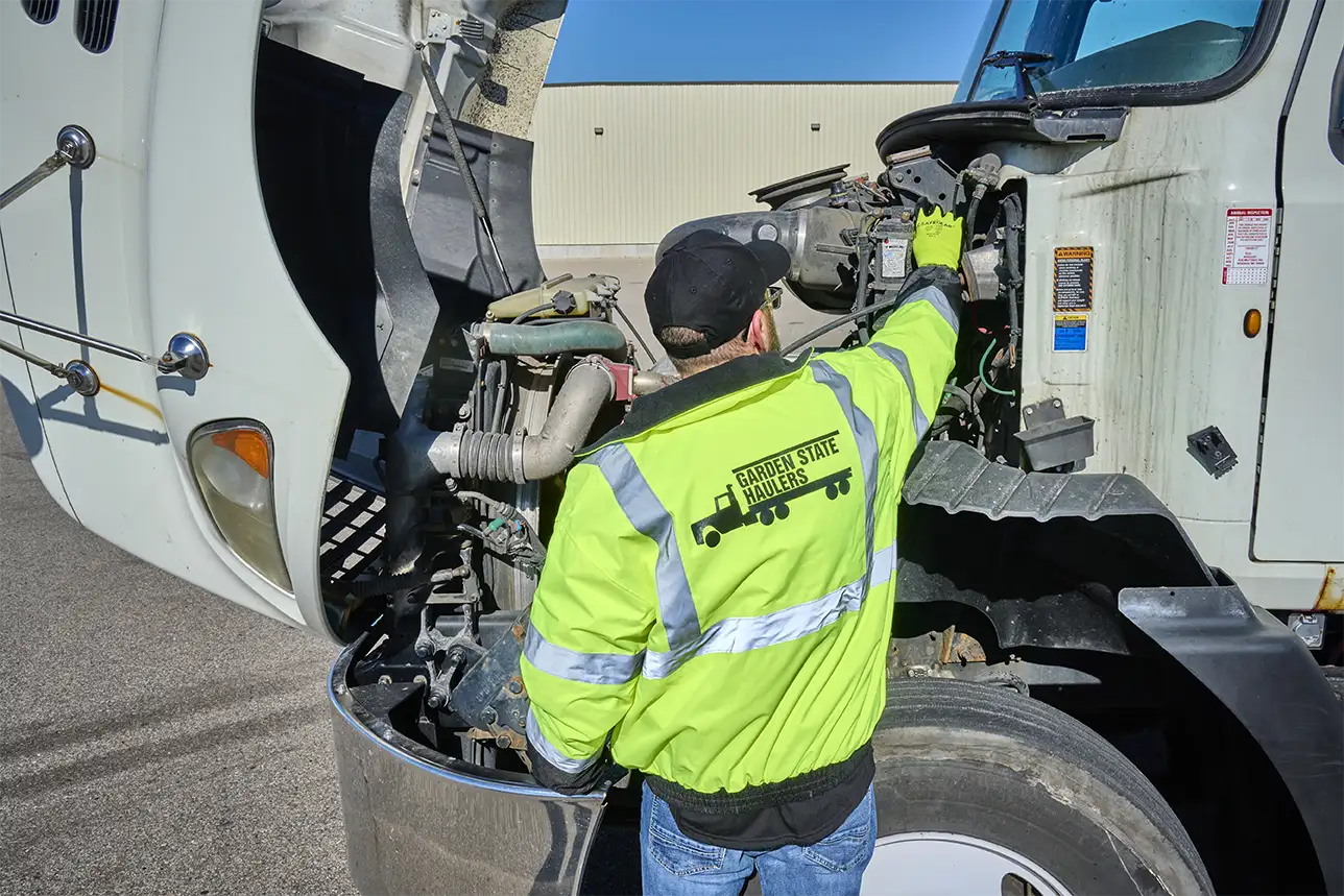 Several workers meeting on a construction site wearing proper PPE