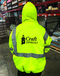 Man showing back of PPE sweatshirt with Craft Vermont logo.