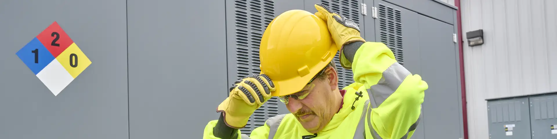 Worker adjusting hard hat